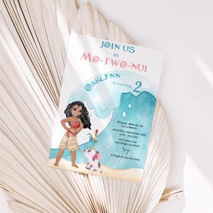 May include: A rectangular birthday invitation card featuring a cartoon girl with long dark hair, a pig, and a rooster on a sandy beach with a large blue wave. The text reads JOIN US in MO-TW-NUI AKLYNN is turning 2, event details, and RSVP info.
