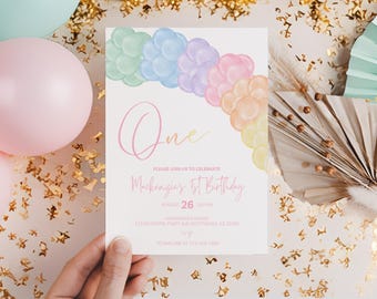 May include: A pastel-colored birthday invitation with a rainbow balloon arch. The invitation reads "One" and "Mackenzie's 1st Birthday" with event details. Pink and mint balloons and gold confetti decorate the background.