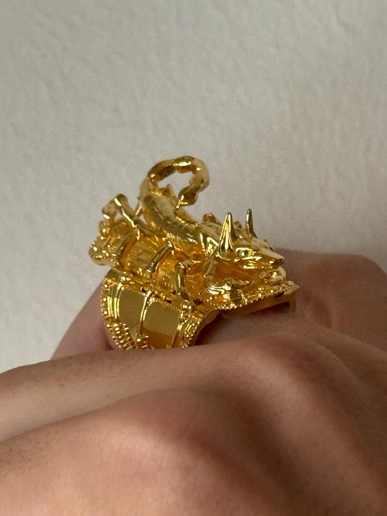 Puede incluir: Un anillo de tono dorado con un dise&ntilde;o de escorpi&oacute;n detallado. El escorpi&oacute;n est&aacute; encaramado sobre una base decorativa, creando un efecto tridimensional.