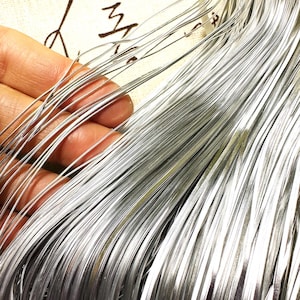 May include: A bundle of silver-coloured wire, likely used for crafting or jewellery making.