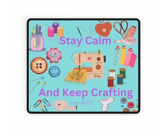 May include: A blue and white digital illustration of a sewing machine, buttons, thread, needles, and other crafting supplies. The text "Stay Calm and Keep Crafting" is written in purple on a blue background.