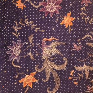 May include: A dark blue fabric with a white polka dot pattern and floral and bird designs in orange, purple, and white. The fabric features a detailed bird in the center and a decorative border along the bottom edge. The overall theme is a textile with an Asian-inspired design.