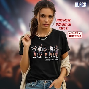 May include: A black t-shirt featuring a graphic print of five illustrated figures in various dance poses with the text "...Posty's Dance Vibes!" and individual labels including "The Cowboy" and "The Daughtruck" printed below the figures.