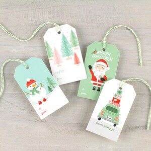 May include: Four Christmas gift tags with festive designs. The tags are white with green and red accents. One tag features a snowman, another has a Santa Claus, another has a car with presents on top, and the last one has a Christmas tree design. Each tag has a string attached for hanging.