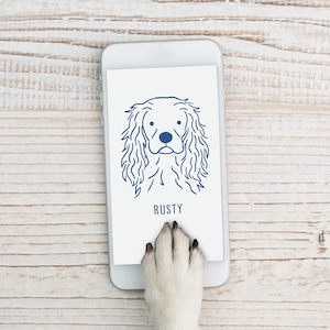 May include: A white smartphone with a blue outline of a dog's head and the word "RUSTY" on the screen. A dog's paw is touching the screen.