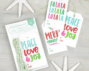 May include: A set of 12 Christmas gift tags with various festive designs. The tags are white with colorful text and include phrases like "Peace Love & Joy" and "Fa La La La La".