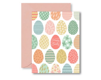 May include: A pink envelope with a white card inside. The card has a pattern of colorful Easter eggs with different designs. The text "Happy Easter" is written in cursive on the card.