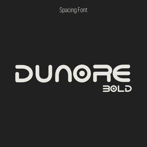 May include: A graphic design featuring the word "DUNORE" in a bold, rounded font, with the word "BOLD" below it. The text is white against a dark gray background. Above the word "DUNORE" is the text "Spacing Font".