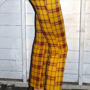 Puede incluir: Pantal&oacute;n de color amarillo y negro a cuadros con un ajuste delgado. El pantal&oacute;n est&aacute; hecho de una tela suave y el&aacute;stica y tiene una cintura alta.