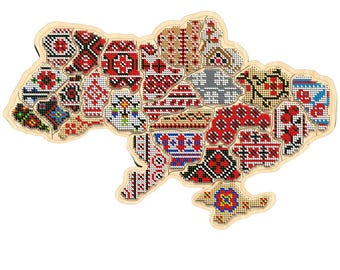 May include: A wooden map of Ukraine with a colorful embroidered design. The map is made of individual pieces that fit together to form the shape of the country. Each piece features a different traditional Ukrainian embroidery pattern.