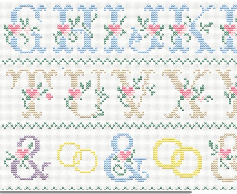 May include: Cross-stitch sampler with letters, ampersands, and wedding rings. The letters are in blue and tan, decorated with pink flowers and green leaves. The wedding rings are yellow. The background is white.