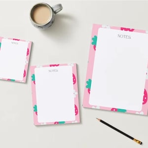 May include: A white ceramic mug with a black handle and the text "But First, Coffee" in a handwritten style. The mug is on a white surface. The mug is 4 inches tall.