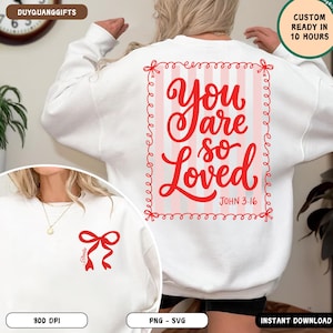 May include: White sweatshirt with a red bow graphic on the front and a larger design on the back. The back design features the words "You are so Loved" in red script within a pink striped frame. The text "John 3:16" is also included.
