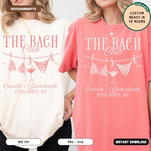 May include: Two t-shirts, one cream and one coral, with a design for "The Bach Club." The design includes a bikini, cocktail, and text "Camila's Bachelorette, Playa Norte, MX." Additional text includes "Custom Ready in 10 Hours."