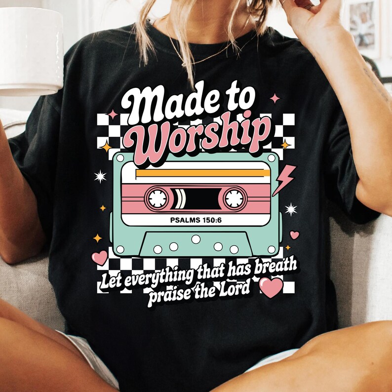 Pu&ograve; includere: Maglietta nera con un design a cassetta retr&ograve; e il testo "Made to Worship" e "Let everything that has breath praise the Lord". La cassetta ha il testo "Psalms 150:6" su di essa.