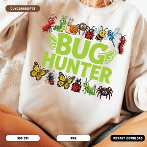 May include: White sweatshirt with a green "BUG HUNTER" graphic and colorful cartoon insects. The design includes butterflies, bees, ladybugs, a spider, and other bugs. The sweatshirt is a comfortable, casual style.