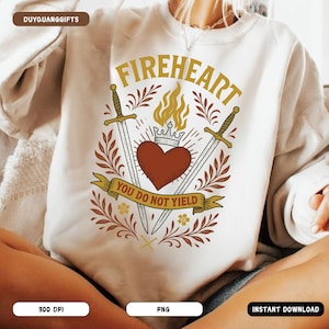 May include: A white sweatshirt featuring a graphic design of a heart with flames, two swords, and a crown. The text "FIREHEART" is above the heart and the text "YOU DO NOT YIELD" is below the heart.