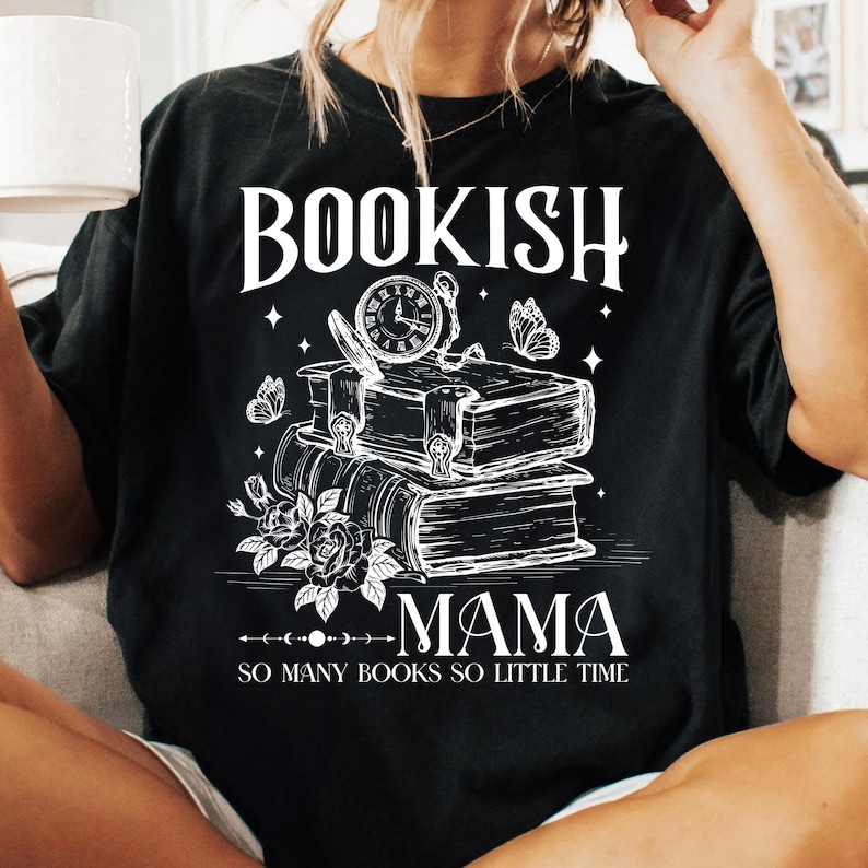 May include: Black t-shirt with white text that reads "Bookish Mama So Many Books So Little Time". The design features a stack of books, a clock, butterflies, and flowers.