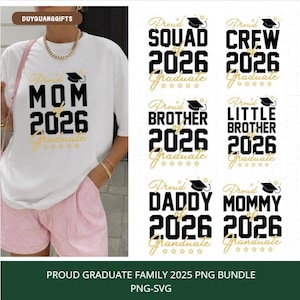 May include: White t-shirt with the text "Proud Mom of 2026 Graduate" in black and gold. The image also shows other graduation-themed designs, including "Squad," "Crew," "Brother," and "Daddy."