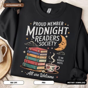May include: Black sweatshirt with a graphic design featuring a stack of books, a crescent moon, and the text "Proud Member Midnight Readers Society 12 AM Weekly Meets All are Welcome".