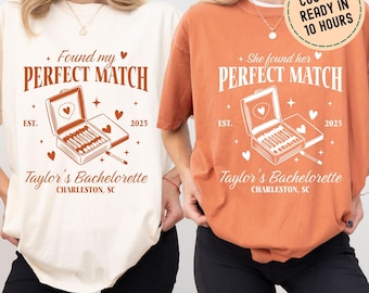 May include: Two white and orange t-shirts with a graphic of a matchbox with the text "Found my Perfect Match" and "She found her Perfect Match" with the text "Taylor's Bachelorette Charleston, SC" and the year "2025".