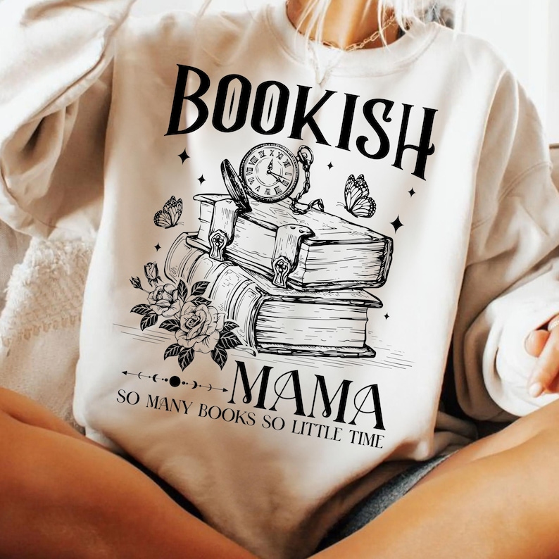 May include: White sweatshirt with a black graphic design of a stack of books, a clock, and butterflies. The text "Bookish Mama So Many Books So Little Time" is printed on the sweatshirt.