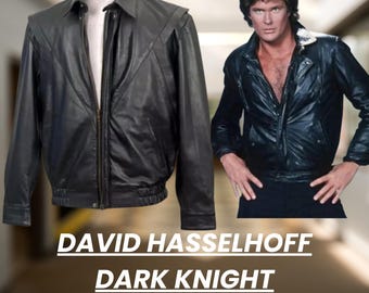 May include: Black leather jacket with a zipper closure, displayed on a mannequin and worn by a person. The jacket has a classic design with a collar and a ribbed hem. Text on the image reads "DAVID HASSELHOFF DARK KNIGHT LEATHER JACKET."