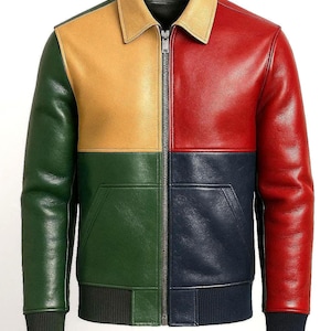 May include: A multi-colored leather jacket with a zip-up front. The jacket features panels of green, yellow, red, and navy blue. It has a tan collar, two front pockets, and black ribbed cuffs and hem.