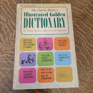 May include: The Courtis-Watters Illustrated Golden Dictionary for Young Readers - Revised and Expanded.  The book cover features colorful illustrations of a train, a panda, a trumpet, and text highlighting key features: over 10,000 basic words, over 20,000 illustrative sentences, over 3,000 helpful illustrations, easy-to-use pronunciation guide, words most frequently encountered, easy to use, easy to read, easy to understand.