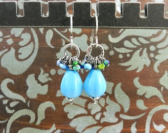 May include: A handmade, wooden cutting board with a natural wood grain. The board has a rectangular shape with rounded corners and a juice groove. The wood is a light brown color.