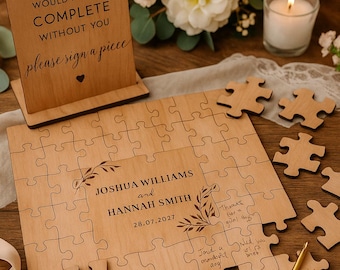 May include: A wooden wedding guest book puzzle with the names Joshua Williams and Hannah Smith, and the date 28.07.2027. The puzzle includes a sign that says "our puzzle would not be complete without you please sign a piece".