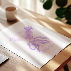May include: A watercolor-style illustration on white paper depicting a martini glass filled with three purple heart-shaped garnishes on a pick. A purple ribbon is tied around the stem of the glass, which is rendered in light purple outlines.