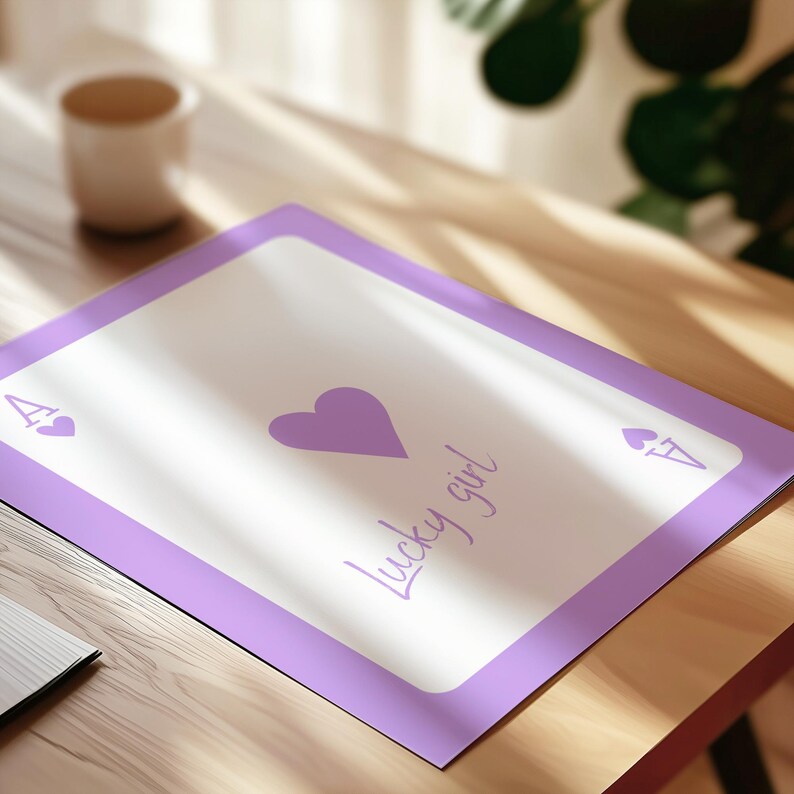 May include: A rectangular print designed like a playing card with a light purple border and a white center. The center features a large purple heart and the text "lucky girl" in cursive script. The corners display the letter A and a small heart.