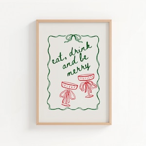 May include: A framed print with the words "eat, drink and be merry" in green script. The print features two red cocktail glasses with bows. The border is a green, hand-drawn style.