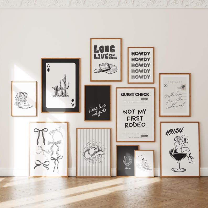 May include: A collection of framed art prints with a Western theme. The prints feature illustrations of cowboy boots, playing cards, cacti, cowboy hats, bows, horseshoes, and the text "Long live cowgirls", "Howdy", and "Not my first rodeo".