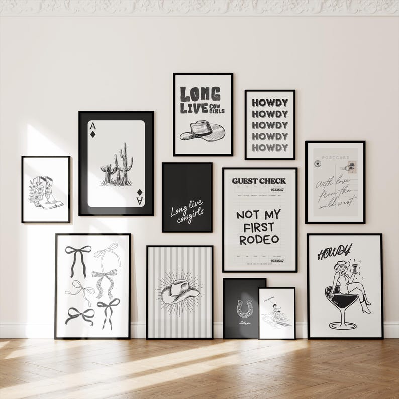 May include: A collection of framed art prints with a Western theme. The prints feature illustrations of cowboy boots, playing cards, cacti, bows, a cowboy hat, and the text "Long Live Cowgirls" and "Howdy". The color scheme is black and white.