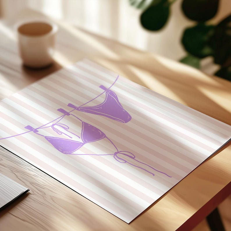 May include: A rectangular print featuring a purple line drawing of a bikini set hanging on a clothesline. The background consists of horizontal light pink and white stripes. The illustration depicts a bikini top and bottom with simple ties.