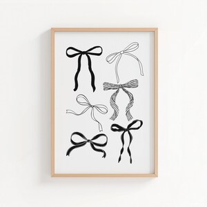 May include: A framed print featuring six different black and white bow illustrations. The bows vary in style, from simple tied bows to more elaborate designs. The artwork is set against a white background, framed in a light wood.