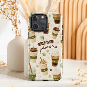 May include: A phone case featuring a repeating pattern of coffee drinks, including iced coffee, lattes, and whipped cream beverages. The phrase "coffee please" is written on a brown banner. The case has a white background with green and brown accents.