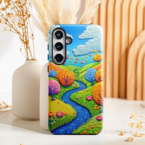 May include: A phone case with a colorful, whimsical design featuring a winding blue river, green trees, and a blue sky with white clouds. The case has a cutout for a camera lens.