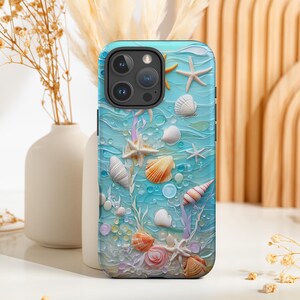 May include: A blue phone case featuring a 3D design of seashells, starfish, and bubbles. The case has a textured surface with various shell types in shades of white, orange, and pink, set against a light blue background, evoking a beach theme.