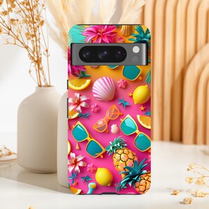 May include: A colourful phone case with a pink background and a variety of summer-themed designs, including pineapples, lemons, seashells, sunglasses and flowers.