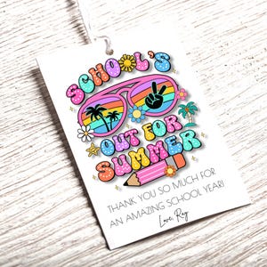 May include: A white gift tag with the text "SCHOOL'S OUT FOR SUMMER" in colorful bubble letters. The design includes sunglasses, palm trees, and a pencil. The tag also says "THANK YOU SO MUCH FOR AN AMAZING SCHOOL YEAR!"
