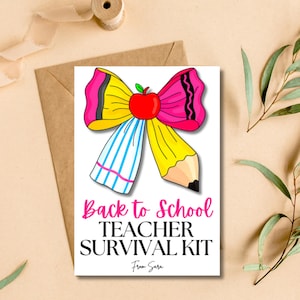 May include: A white card with the text "Back to School TEACHER SURVIVAL KIT" and a pencil-shaped bow with a red apple center. The bow is yellow, pink, and blue. The card is on a brown envelope.