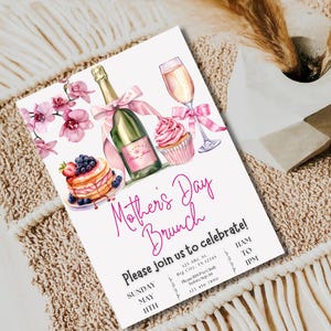 May include: A pink and white invitation for a Mother's Day brunch. The invitation features a champagne bottle, a cupcake, a plate of pancakes with berries, and a glass of champagne. The text on the invitation reads "Mother's Day Brunch" and "Please join us to celebrate!" with the date and time of the event.