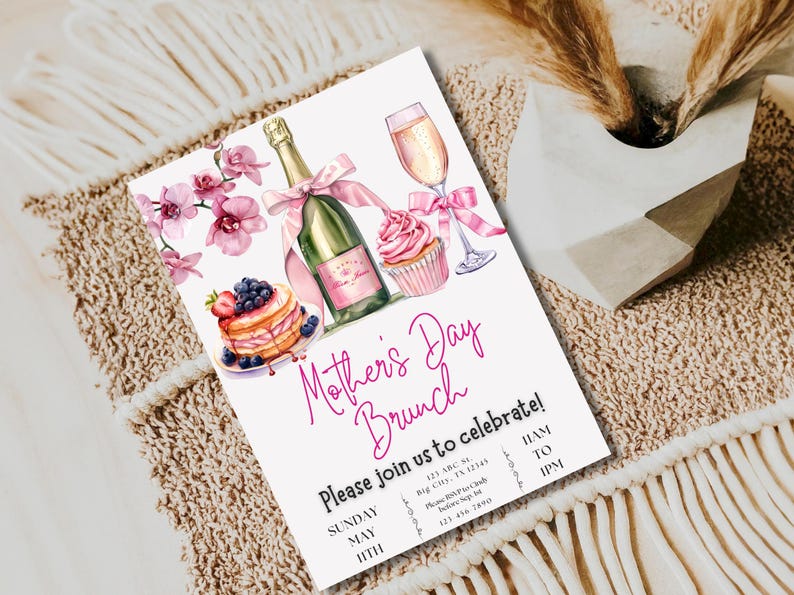 May include: A pink and white invitation for a Mother's Day brunch. The invitation features a champagne bottle, a cupcake, a plate of pancakes with berries, and a glass of champagne. The text on the invitation reads "Mother's Day Brunch" and "Please join us to celebrate!" with the date and time of the event.