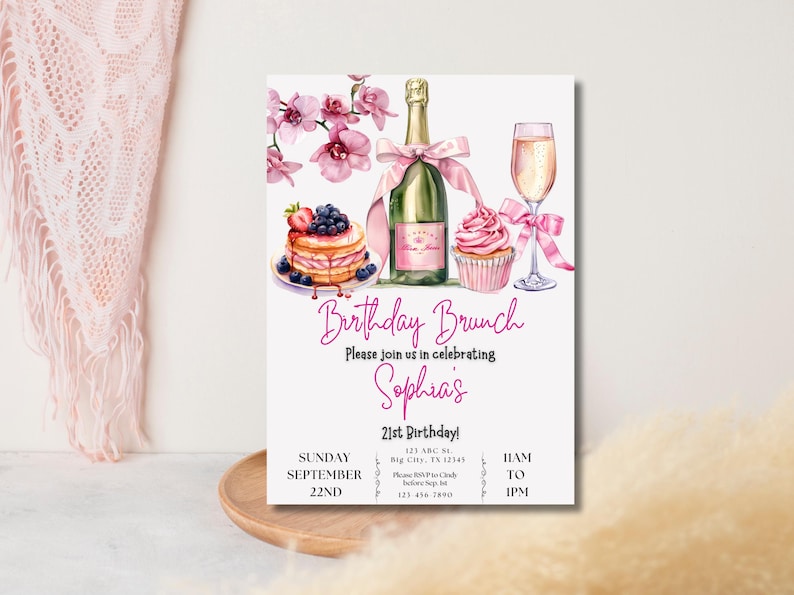 May include: A pink and white birthday brunch invitation with a watercolor illustration of a cupcake, champagne flute, bottle of champagne, and a plate of pancakes with berries. The text reads "Birthday Brunch", "Please join us in celebrating Sophia's 21st Birthday!" and includes the date, time, and location of the event.
