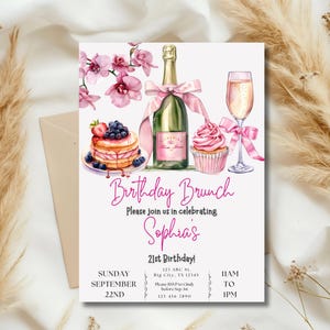 May include: A pink and white birthday brunch invitation with a watercolor illustration of a champagne flute, a bottle of champagne, a cupcake, and a plate of pancakes with berries. The text reads "Birthday Brunch" and "Please join us in celebrating Sophia's 21st Birthday!" with the date and time of the event.