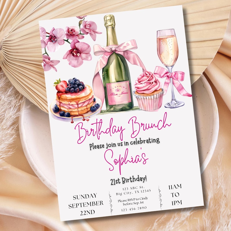 May include: A pink and white birthday brunch invitation with watercolor illustrations of a champagne flute, a bottle of champagne, a cupcake, and a stack of pancakes with blueberries and strawberries. The text on the invitation reads "Birthday Brunch", "Please join us in celebrating Sophia's 21st Birthday!", "Sunday September 22nd", "11AM to 1PM", "123 ABC St. Big City, TX 12345", "Please RSVP to Cindy before Sep. 1st", "123 456 7890".