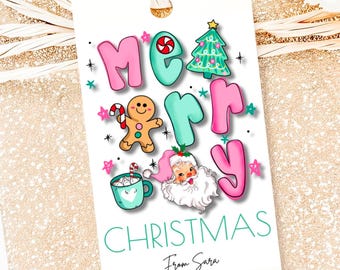 May include: A white gift tag with the words "MERRY CHRISTMAS" in pink and teal bubble letters. The tag features illustrations of a Christmas tree, Santa Claus, gingerbread man, and a cup of hot cocoa. The tag reads "From Sara" at the bottom.